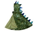 The Great Pretenders Dragon Cape, made from crushed velvet in green with blue and teal spikes on the hood and back, is displayed laid flat to reveal part of its inner lining.
