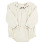 The Beaufort Bonnet Company’s Baby Girls' Long Sleeve Bridget Bubble is a cream romper with black trim and ruffle accents on the collar, cuffs, and leg openings, offering a classic smocked bubble style.