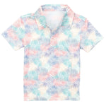 The Boys' Inlet Polo by Properly Tied is a short-sleeved, pastel palm leaf patterned shirt in blue, pink, and beige. It features a collar and buttoned front made from moisture-wicking fabric for all-day comfort.