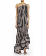 A person wearing the Lanvin Asymmetrical Cascade-Effect Dress, an ankle-length, one-shoulder zebra-print style with abstract black and beige stripes, integrated bustier, ruffled hem, paired with strappy sandals.