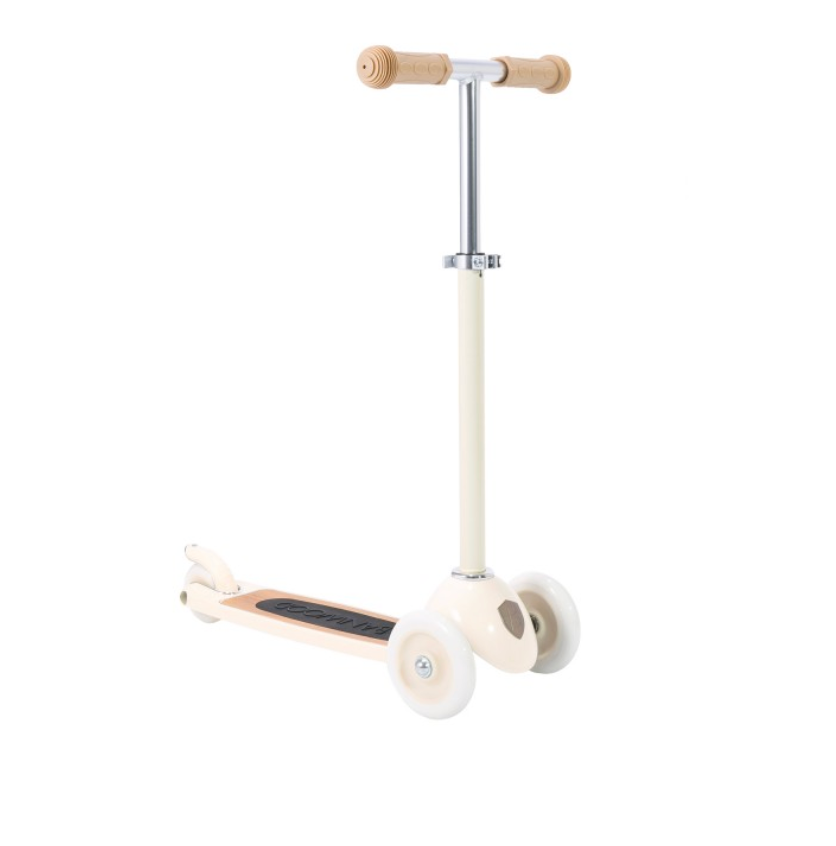 The Banwood Scooter is a beige and white three-wheeled toy with tan handlebars and a black footboard, shown on a white background. It features an angle control system for improved development and coordination.