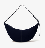 The Proenza Schouler Slide Suede Bag features a crescent shape, soft suede construction, single adjustable strap, and curved silhouette, shown against a plain white background.