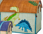 The Rice Raffia Toy Basket features a green dinosaur on the lid and a blue stegosaurus on the side, adding playful charm. A smaller matching basket is partially visible, perfect for fun and practical storage.