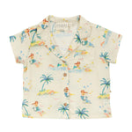 The Arsene & Les Pipelettes Baby Girls' Flynn Shirt is a cream short-sleeve top featuring a playful mermaid, palm trees, swimmers print, button-down front, and notched collar.