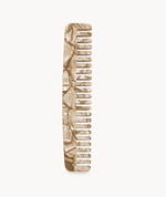 Comb No. 3 by Machete, crafted from Italian bio-acetate in beige marble, features wide and narrow teeth and is shown vertically on a plain white background.