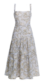 The Lima Midi Dress by Agua By Aguabendita is a sleeveless, tiered creation with floral patterns and delicate spaghetti straps, complemented by a long, flowing skirt with layers of sky-blue tulle for an ethereal and elegant touch.