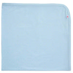 The Pin Dot Modal Baby Blanket by Magnetic Me is light blue with small white polka dots, rounded edges, and a red-and-white tag. Ideal as a stroller blanket for your little one.