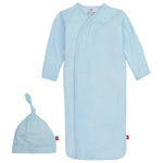 Magnetic Me's Baby Pin Dot Blue Gown & Hat Set in light blue is crafted from TENCEL™ modal, featuring a knotted hat with a subtle polka dot pattern and convenient mitten cuffs for added comfort.