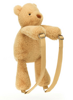 A plush, beige teddy bear with adjustable straps, resembling a Jellycat Smudge Bear Backpack by Jellycat, is shown against a white background.