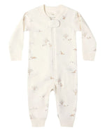 The Quincy Mae Baby Long Sleeve Zip Sleeper features a cream color, front zipper, and a subtle animal and tree print pattern.
