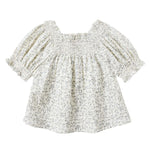 The Girls' Ada Blouse by Rylee & Cru is a cream, short-sleeved smocked top with a small floral print, square neckline, and subtle puff sleeves for a charming touch.