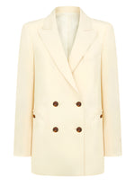 The Savannah Everyday Blazer by Blaze Milano is a classic cream-colored piece featuring a double-breasted design with brown buttons, peak lapels, two front pockets, and crafted from a luxurious silk and linen blend.