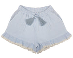 The Girls' Ambroise Shorts by Early Sunday are light blue and white striped with a ruffled hem and lace trim. They feature an elastic waistband with a drawstring bow.