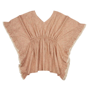 The Girls' Tony Kaftan by Early Sunday is a soft cotton cambric poncho featuring a delicate Garden Flower print with ruffled edges and a V-neckline in a pink, floral pattern.