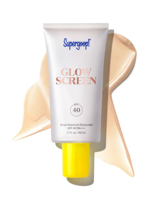 A tube of Supergoop Glowscreen SPF 40 in Sunrise, featuring a yellow cap and shown with a dab spread behind it, provides a luminous finish and all-day hydration.