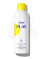 The Supergoop Play Antioxidant Mist with Vitamin C SPF 50 is a 6 fl oz sunscreen spray with a white body and yellow cap, featuring a splash of water. It's water-resistant and perfect for sunny adventures.