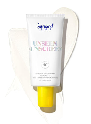 A tube of Supergoop Unseen Sunscreen SPF 40 is displayed on a white background with a smear of the invisible, weightless formula behind it.