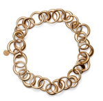 The Laura Necklace by Lie Studio is a bold gold-tone chain with chunky interlocking circular links, finished with a small round tag near the clasp for an elegant touch.