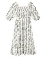 The Girls' Della Dress by Rylee & Cru is a white, ankle-length dress with puffed sleeves, a gathered bodice, vertical green floral print, and delicate crochet trim.