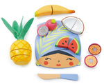 The "Tropical Fruit Chopping Board" by Tender Leaf Toys is an exotic wooden toy set featuring a face-shaped board with velcro-attached fruit pieces like pineapple, banana, and watermelon, plus a blue knife for imaginative play.