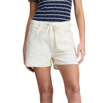 A person is wearing Rag & Bone’s Ultra Featherweight Nolan Drawstring Short in cream, paired with a navy striped, short-sleeved Lyocell top; only the torso and upper legs are shown.