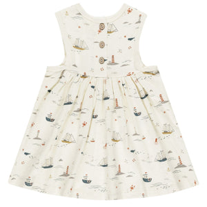 Rylee & Cru's Layla Dress for baby girls and girls is a sleeveless cream babydoll style with back buttons, featuring a nautical print of ships, lighthouses, and waves.