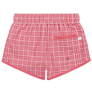 The Minnow Boys' Malibu Poppy Gingham Boardie features a red and white checkered print, elastic waistband, stretch liner for comfort, a back flap pocket, and a small white tag on the pocket.