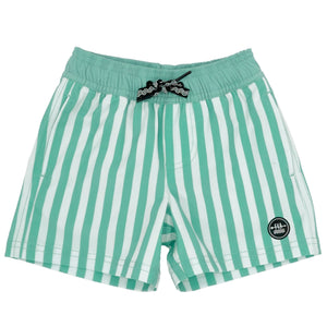 The Baby Boys' Sun Club Volley Trunk by Feather 4 Arrow features green and white vertical stripes, an elastic waistband with a black drawstring, and a logo patch on the lower right leg. Made from lightweight fabric, these shorts offer quick-drying comfort.