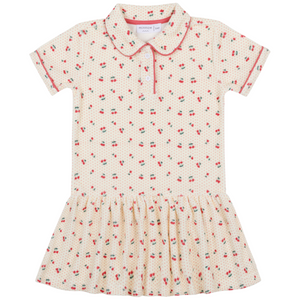 The Minnow Girls' Summer Cherries French Terry Drop Waist Tennis Dress features short sleeves, a red cherry print on cream, a collared button neckline, gathered skirt, and soft french terry fabric for all-day comfort.