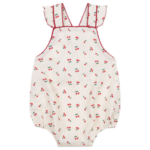 The Minnow Baby Girls' Summer Cherries Crossover Ruffle Strap Bubble features a cream base with red cherry print, small polka dots, ruffled crossover straps, red piping, and an open back design.