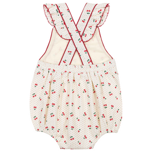 The Minnow Baby Girls' Summer Cherries Crossover Ruffle Strap Bubble is a white romper with ruffled shoulder straps crisscrossed at the back, featuring a cherry print and tiny polka dots.