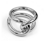 The Lie Studio Agnes Ring features two interlocking polished metal loops forming an elegant, continuous knot—an intricate addition to your ring collection.