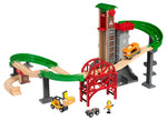 The Brio Lift & Load Warehouse Set includes green tracks, a red stackable bridge, an orange train, a tall building, and a toy crane. It also features two figures for endless adventures.