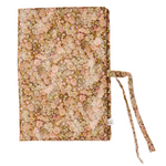 The Bonpoint Ebba Health Record Cover, crafted from Liberty Fabrics with a pink and green floral pattern and tie closures, is shown against a white background—ideal for keeping your baby’s documents organized.