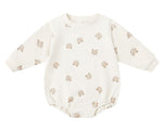 The Quincy Mae Baby Crewneck Bubble Romper features cream-colored French terry, long sleeves, and a cute cartoon bear face pattern—ideal for your baby's transitional wardrobe.