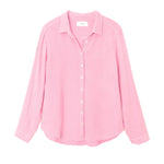 A pink Xirena Scout Shirt with long sleeves, collar, and buttons is laid flat on a white background.