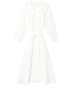 The Andrea Dress by Xirena is a white, long-sleeve, button-down midi dress featuring a cinched waist tie and soft textured cotton gauze fabric, shown laid flat on a white background.