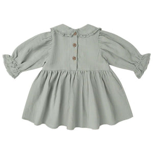 The Quincy Mae Baby Girls' and Girls' Marisol Dress features light grey fabric, a gathered skirt, wooden back buttons, and lace ruffle trim on the collar and sleeves.