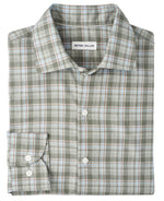 A folded long-sleeve button-up with a green, white, blue, and brown plaid pattern. The Peter Millar Whitecap Performance Flannel Sport Shirt is crafted from lightweight fibers—perfect for fall.
