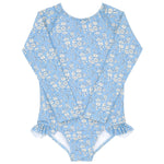 The Minnow Baby Girls and Girls Capel Rashguard One Piece is a blue long-sleeve swimsuit with a white floral pattern from Liberty Fabrics, featuring ruffled leg openings.