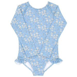 The Minnow Baby Girls and Girls Capel Rashguard One Piece is a blue long-sleeve swimsuit with a white floral pattern from Liberty Fabrics, featuring ruffled leg openings.
