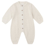 The Baby Girls' Long Sleeve Bubble Romper by Quincy Mae features a cream hue, button-down front, and textured diamond pattern in soft pointelle fabric for comfort.