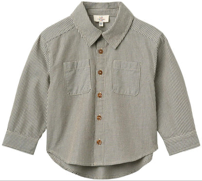 The Baby Boys’ and Boys’ Checkered Classic Shirt by Copenhagen Colors features long sleeves, 2 chest pockets, brown buttons, and a black-and-white small checkered pattern.