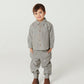 A young child faces forward in the Baby Boys’ and Boys’ Checkered Classic Shirt by Copenhagen Colors, paired with pants and brown boots, against a plain white background.
