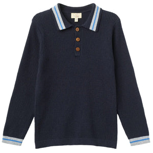 The Boys’ Knitted Waffle Polo Long-Sleeved Polo by Copenhagen Colors features navy blue knit, ribbed texture, button placket, and light blue and white striped collar and cuffs.
