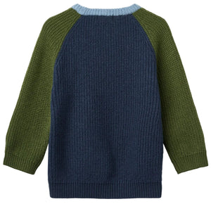 The Baby Boys’ and Boys’ Merino Ribbed Knitted Top by Copenhagen Colors features a navy body, olive sleeves, and a light blue ribbed neckline, shown from the back.