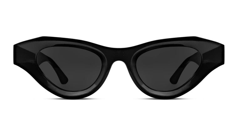 A pair of black, cat-eye sunglasses from the Thierry Lasry eyewear collection with dark tinted lenses seen from the front.