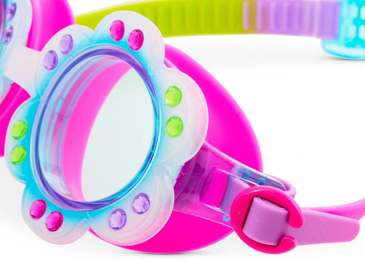 Close-up of Bling2O Petals Swim Goggles featuring a playful floral ombre pattern, flower-shaped frame with green and purple studs, pink strap, and clear lenses.