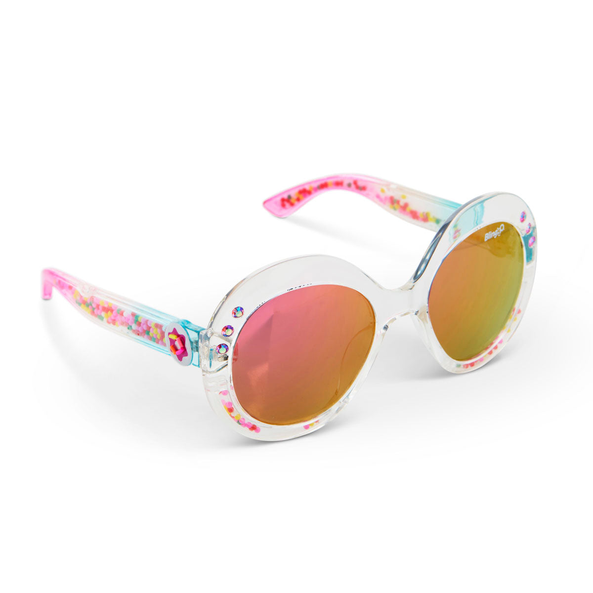 Girls’ Glass Beach Sprinkle Sunrise Sunglasses by Bling2O feature round clear frames, pink-tinted gradient UV-protected lenses, and a playful sprinkle-inspired design with colorful decorative details adorning the arms and rims.