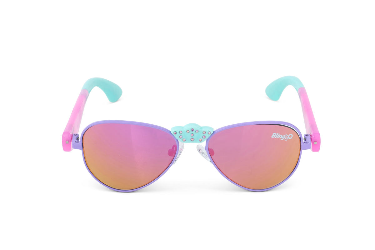 The Bling2O Girls’ Hampton Beach Sunglasses feature purple and pink frames with mirrored, UV-protected lenses, blue-green accent arms, and a sparkling blue cloud with rhinestones above the nose bridge—making them the perfect stylish accessory for the beach.